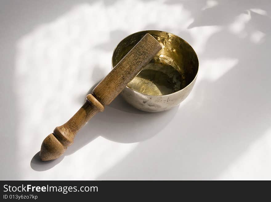 Bronze singing bowl or standing bell, with wooden mallet, used in Buddhist spiritual traditions, for meditation, relaxation, healthcare, personal well-being and religious practice. Bronze singing bowl or standing bell, with wooden mallet, used in Buddhist spiritual traditions, for meditation, relaxation, healthcare, personal well-being and religious practice.