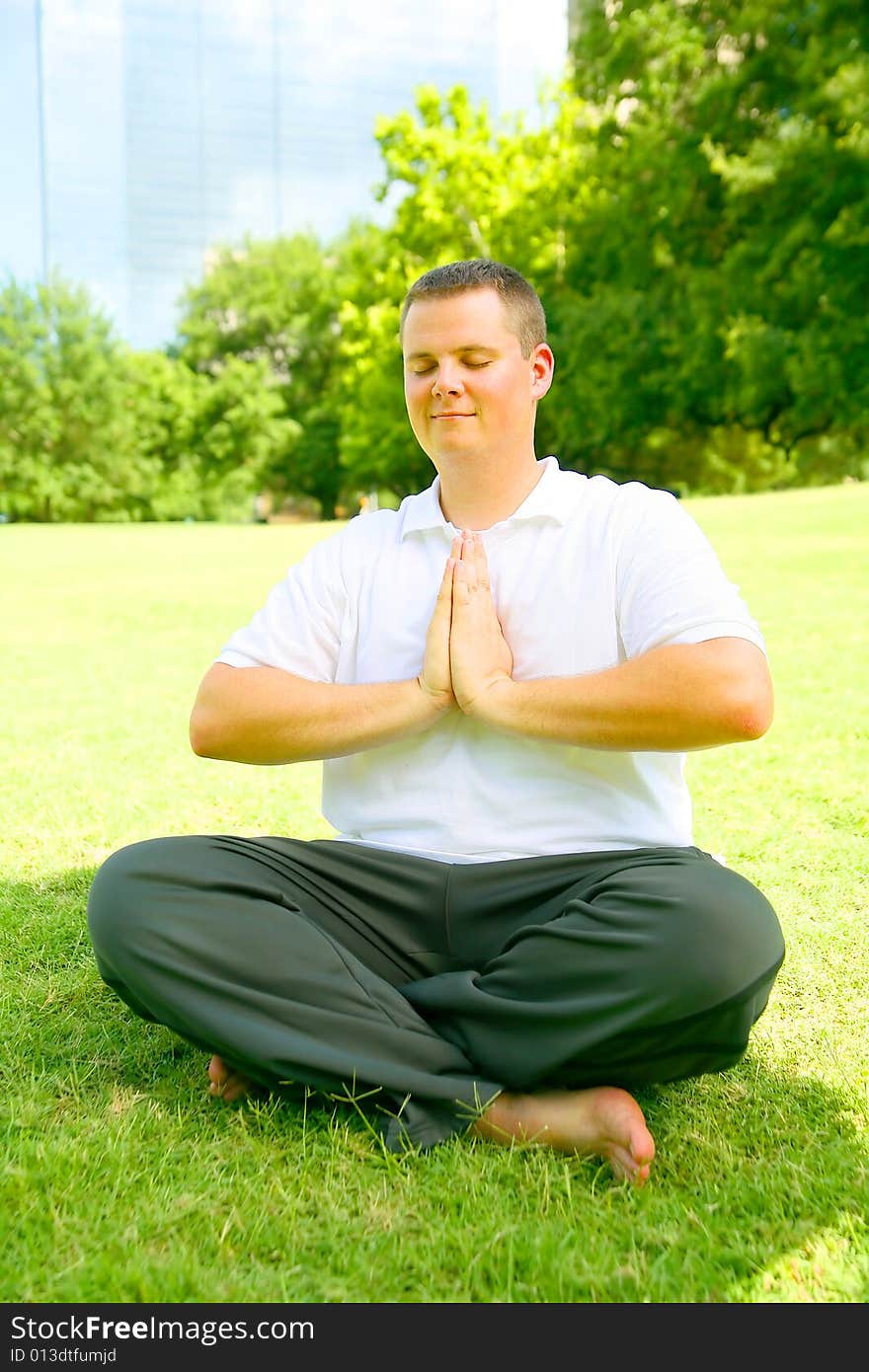 Handsome caucasian man meditate outdoor in a park. concept for yoga or wellbeing. Handsome caucasian man meditate outdoor in a park. concept for yoga or wellbeing