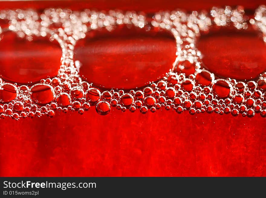 Red bubbles water under glass bottle