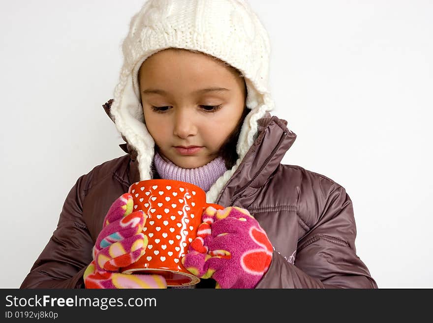 Little girl with cup of hot tea