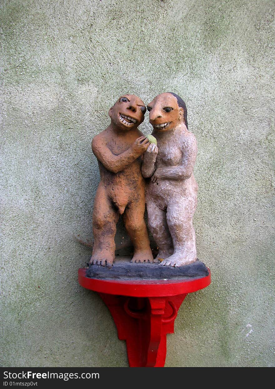 Two sculpture of laughing figurines at the old wall in Cesky Krumlov. Two sculpture of laughing figurines at the old wall in Cesky Krumlov