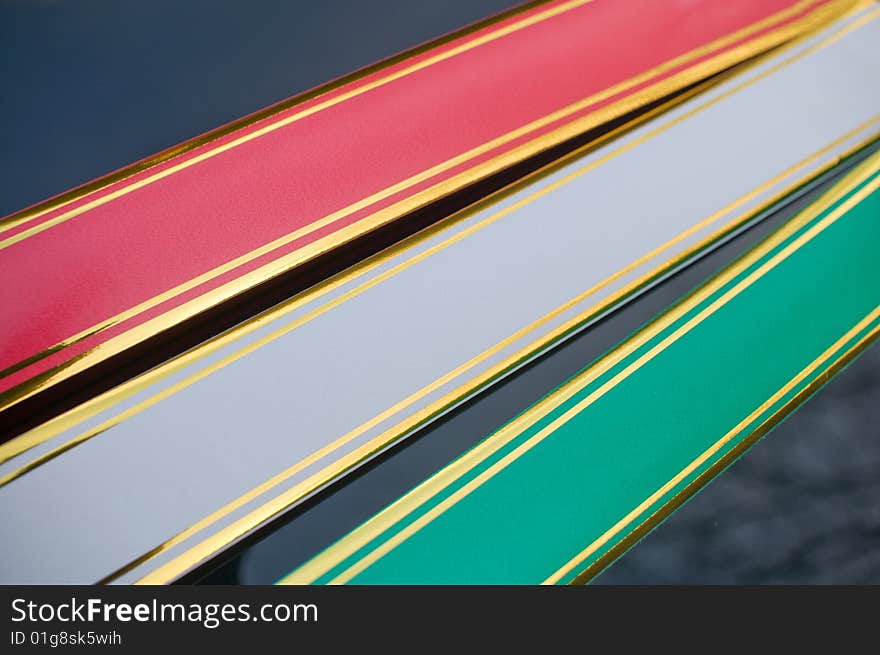 Three colourful tapes decorate a cowl of the wedding car. Three colourful tapes decorate a cowl of the wedding car.