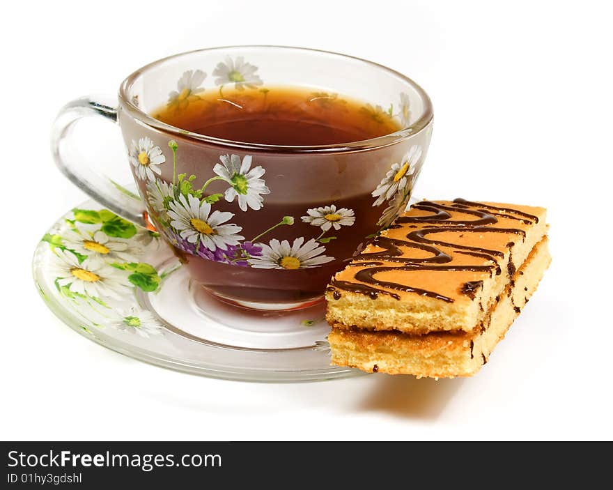 Cap of tea on saucer with cake