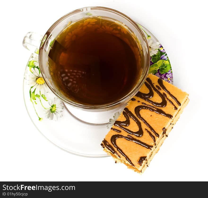 Cap of tea on saucer with cake