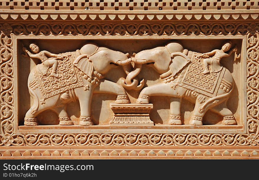 Fine sculptures of men riding elephant on marble wall