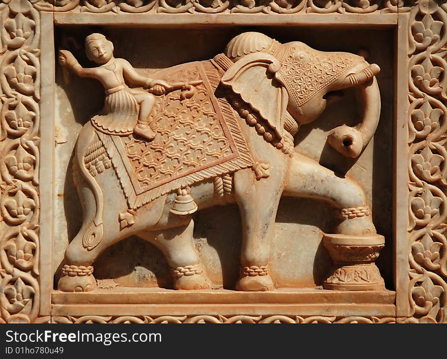 Fine sculptures of man riding elephant on marble wall