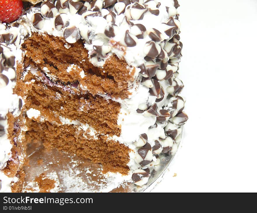 Cut cake with chocolate chips and berries (left)