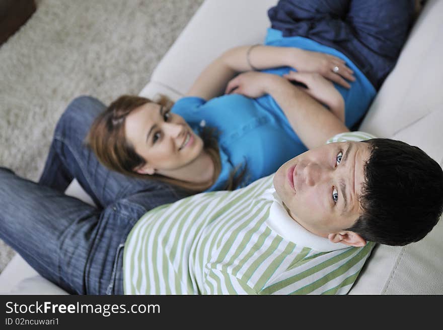 Couple relax at home on sofa in living room