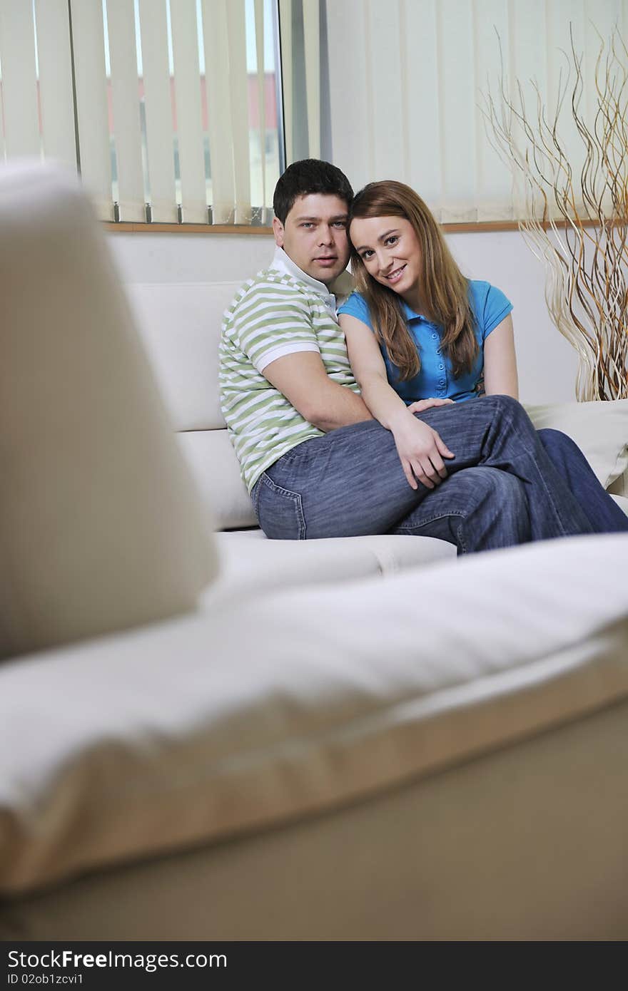 Couple relax at home on sofa in living room