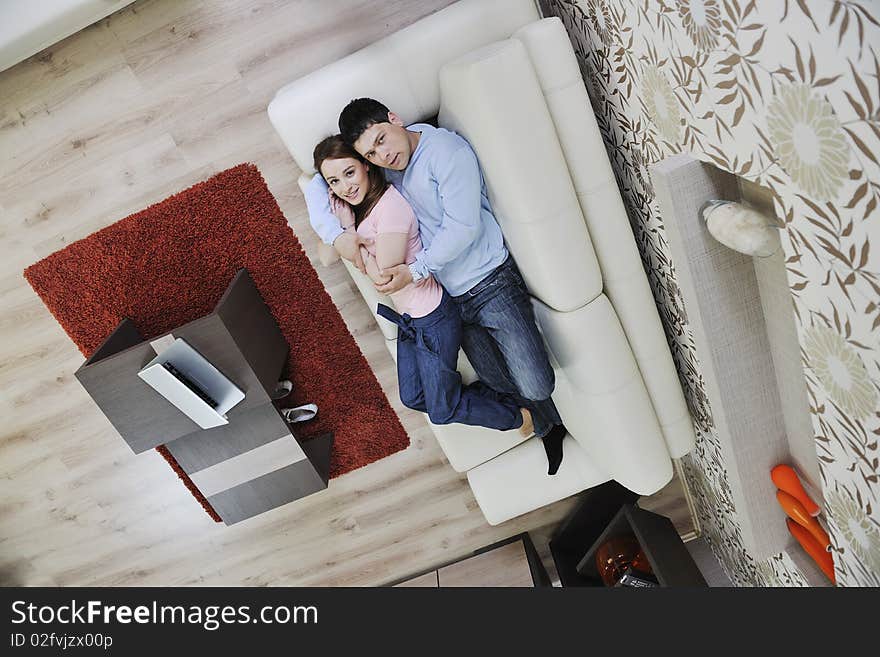 Couple relax at home on sofa