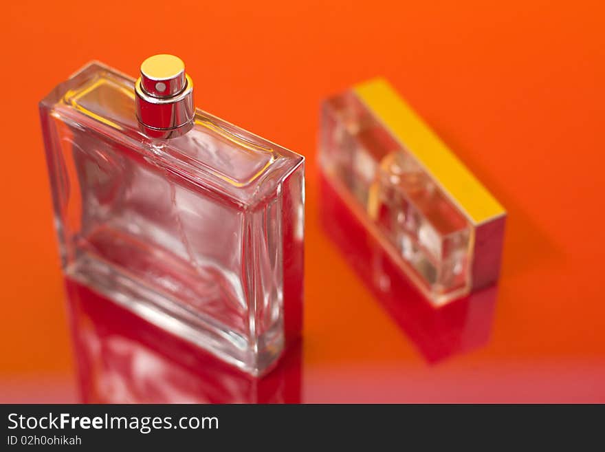 Bottle of perfume on the red. Bottle of perfume on the red