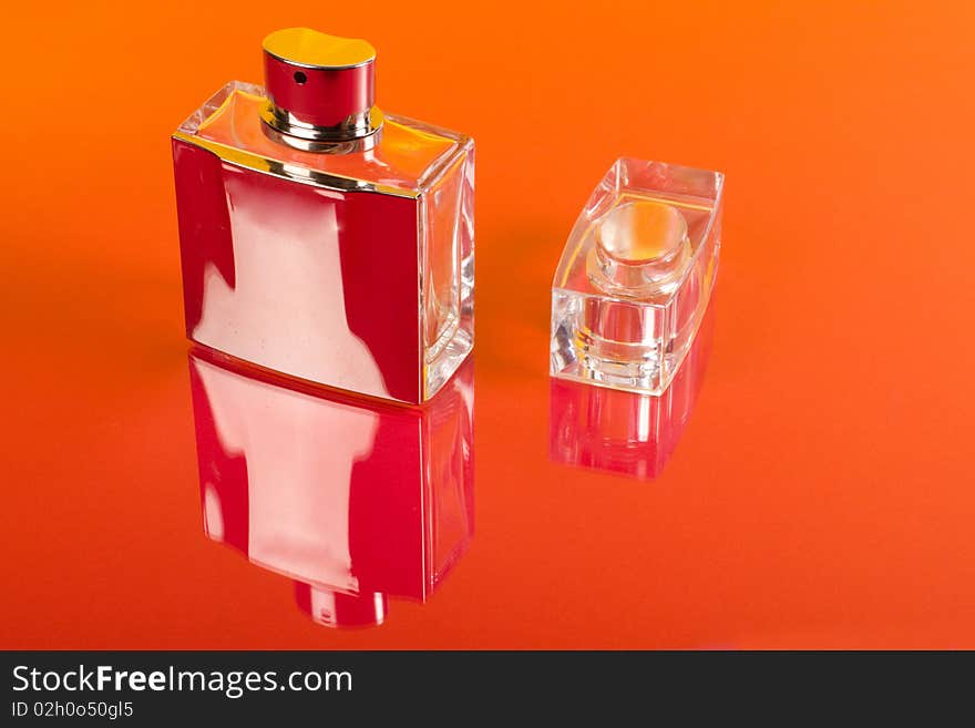 Bottle of perfume isolated on the red