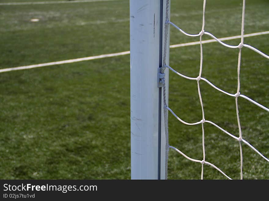 Closeup on the soccer goal post with the penalty spot in the background. Closeup on the soccer goal post with the penalty spot in the background