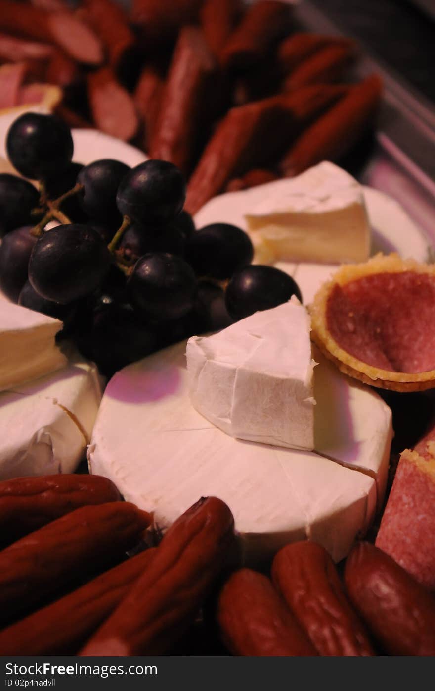 Meat and brie on a platter.