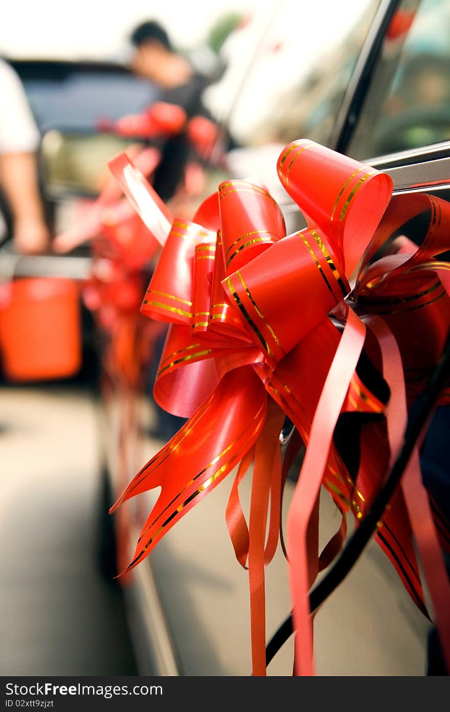 Red silk ribbons on Wedding car. Red silk ribbons on Wedding car