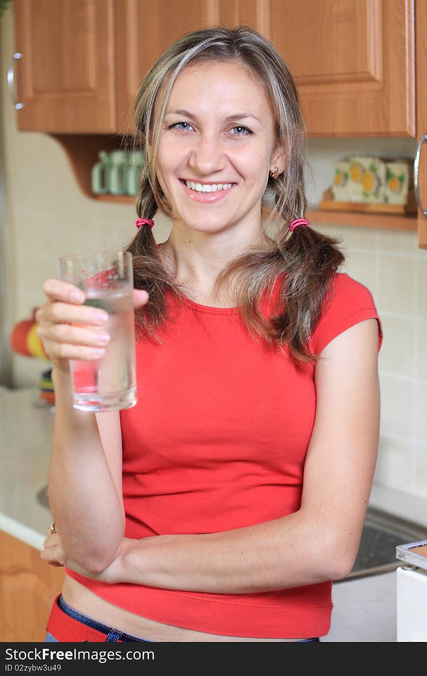 Young woman drinking water at home