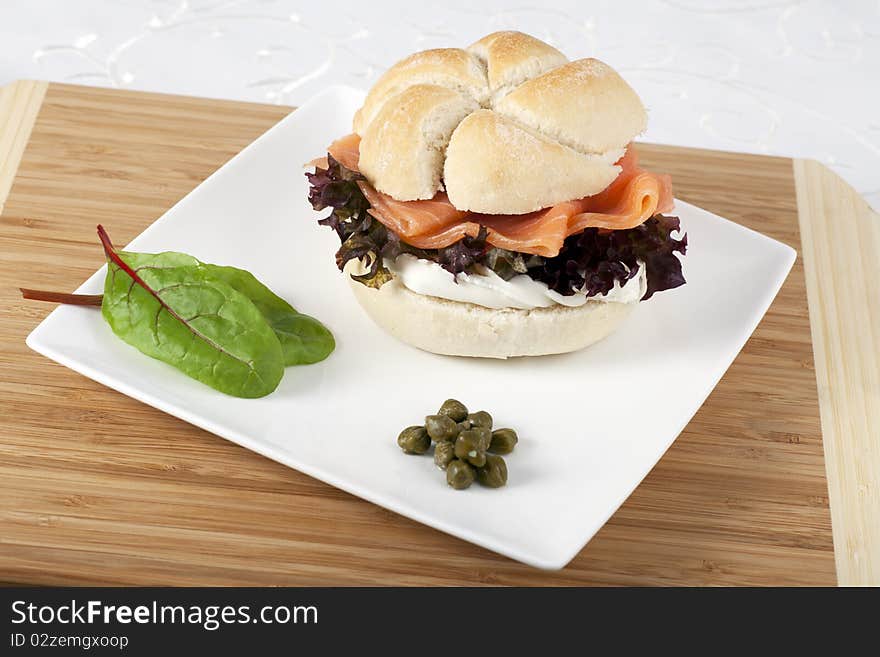 Smoked salmon and cream cheese on roll with capers. Smoked salmon and cream cheese on roll with capers.