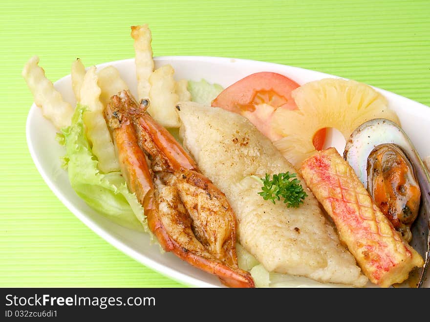 Fresh seafood platter with fried potatoes.