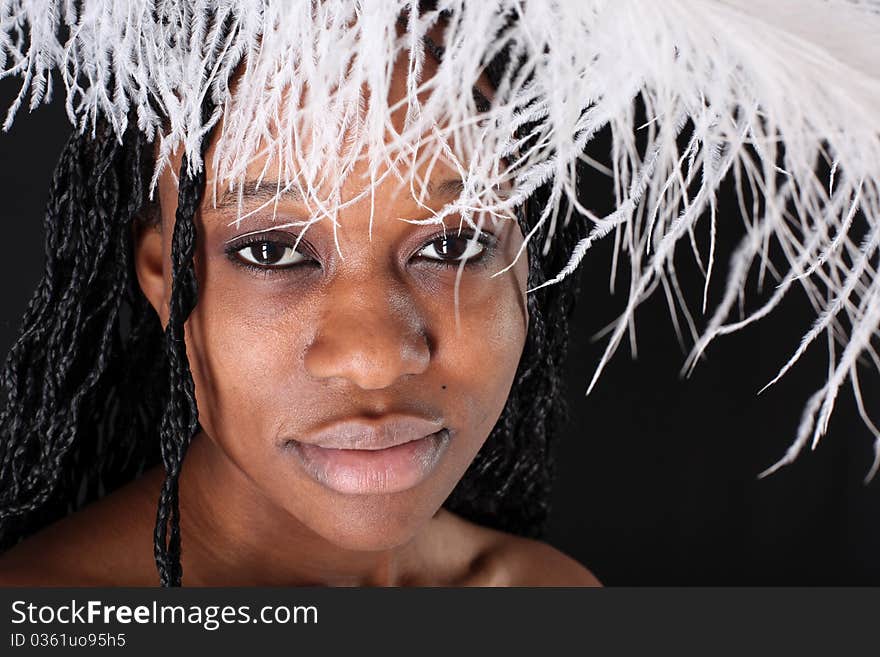 Afro-american woman with white feather against black background