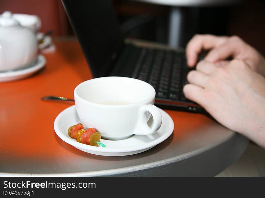 Cap of tea and netbook