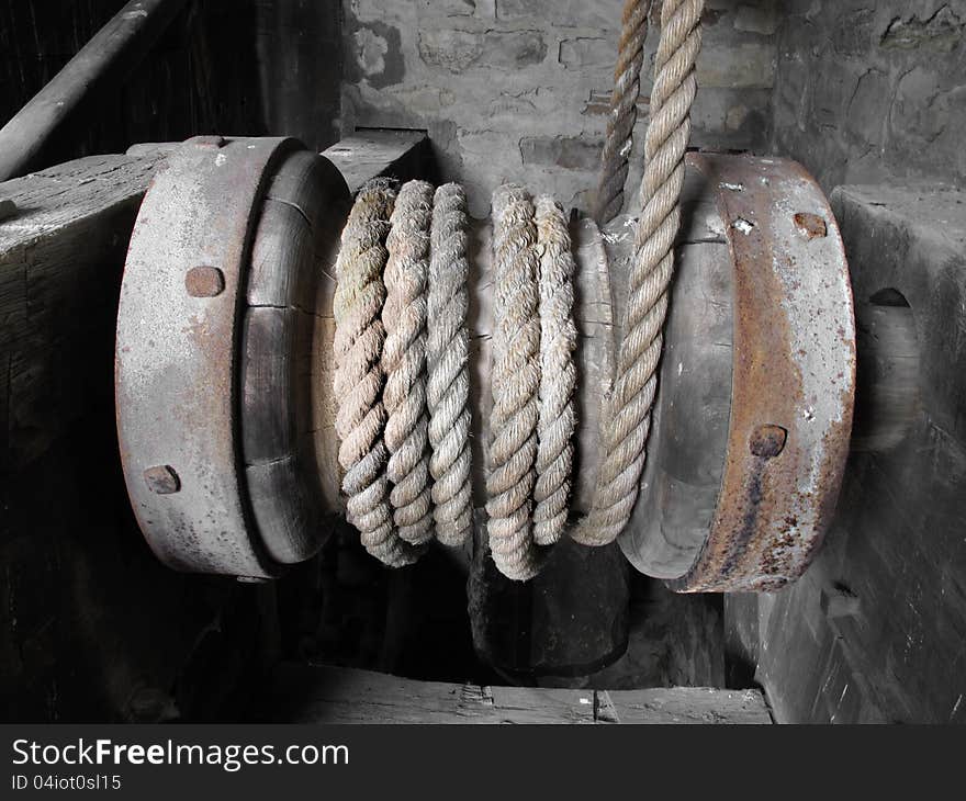 Wooden horizontal windlass wound with hemp rope, inside a structure. Wooden horizontal windlass wound with hemp rope, inside a structure.