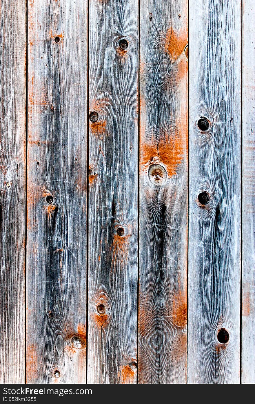 Wooden fence of smoky color with knots