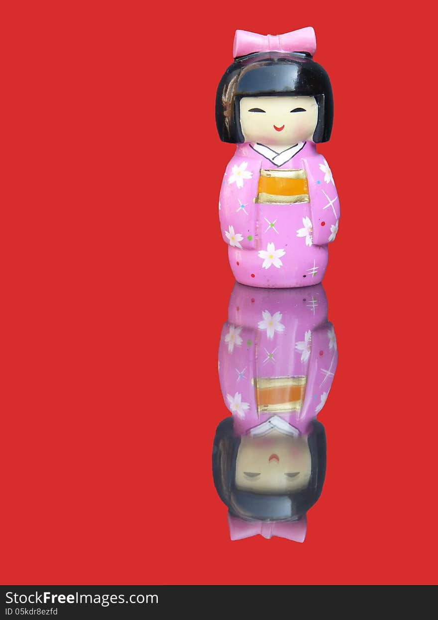 Porcelain chinese figurine with mirror image  on a red background