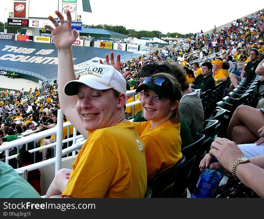 Smile, Sunglasses, Cap, Baseball cap, Gesture, Fan