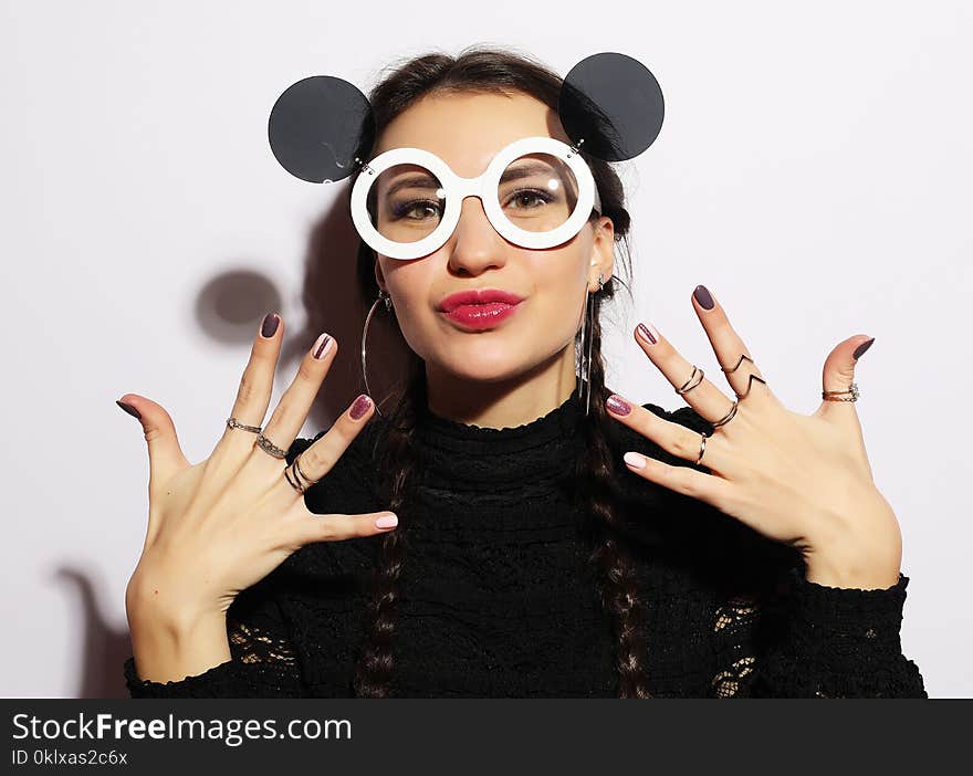 Fashion concept. Beauty surprised fashion model girl wearing big sunglasses. Young girl. Makeup. Over white background.