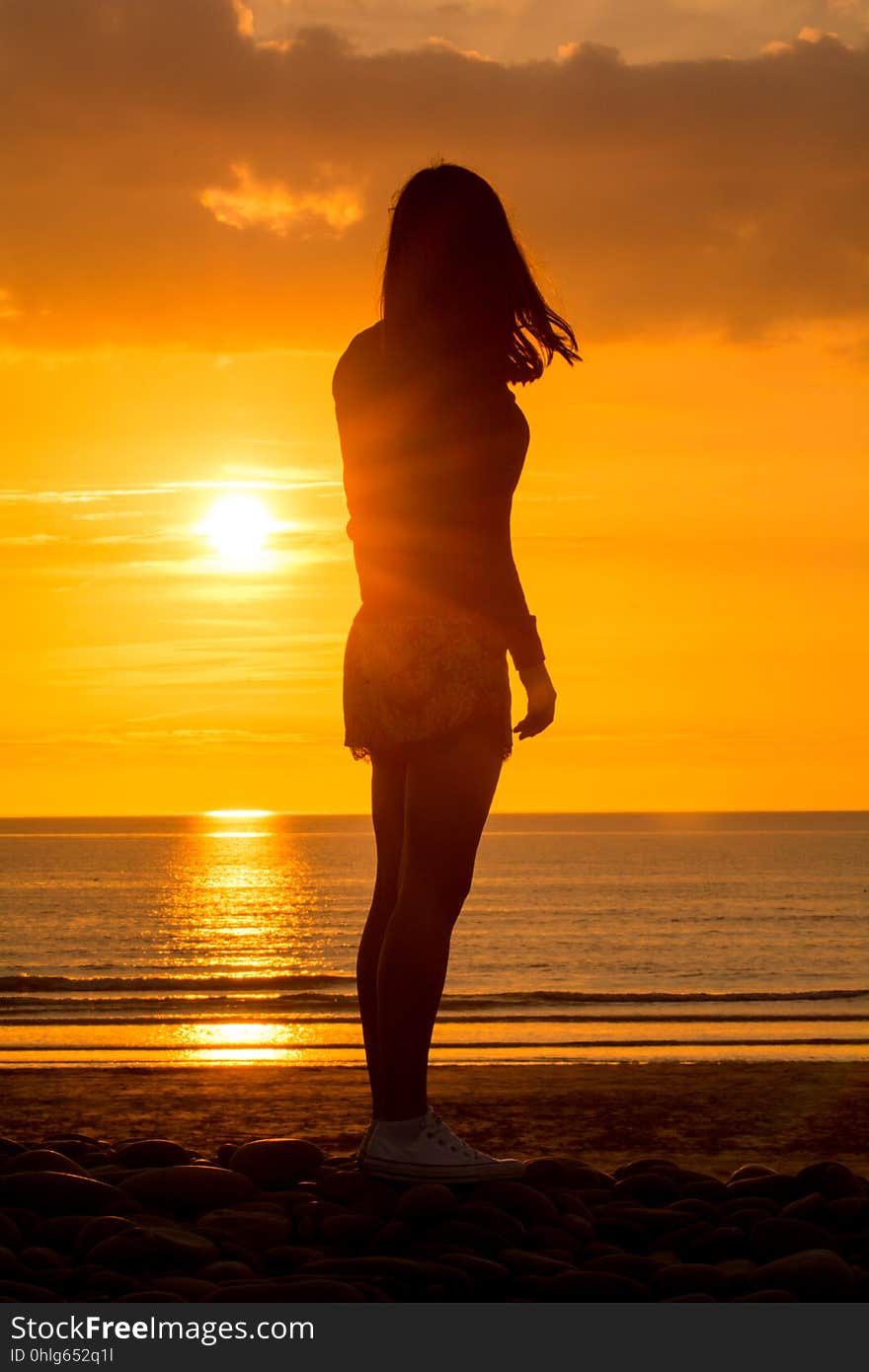 Yoga Woman doing yoga pose outside in sunset setting outdoors