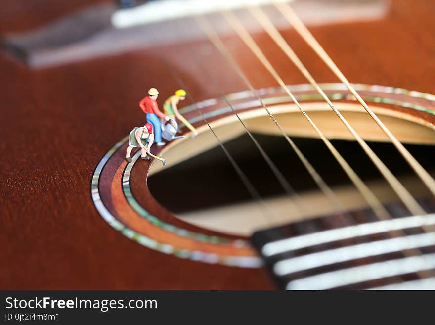 Miniature people : worker team with acoustic guitar,time of relax or music relax,stationary,education concept.