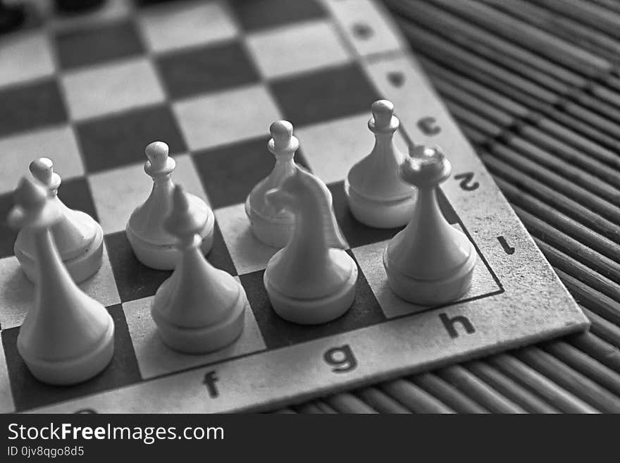 Monochrome Wooden Chess Board and steel chess pieces, on board