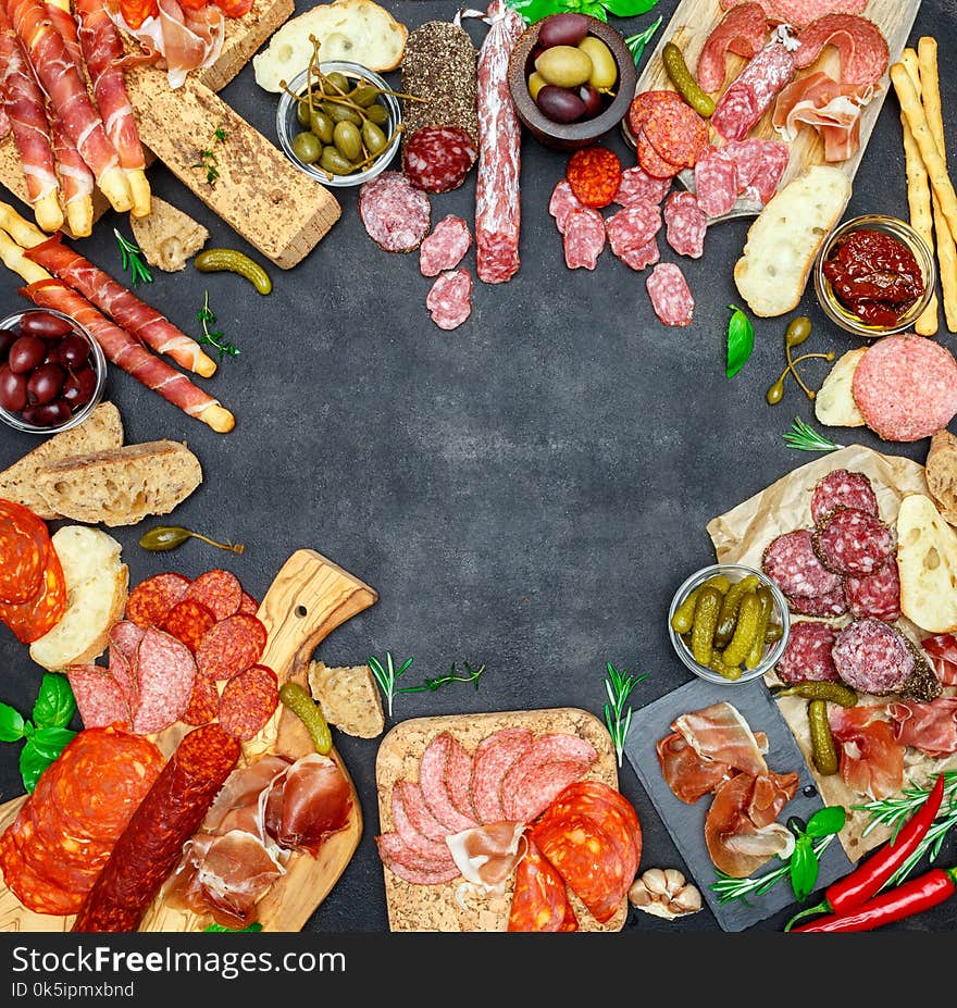 Italian meat appetizer snack set. Salami, prosciutto, bread, olives, capers