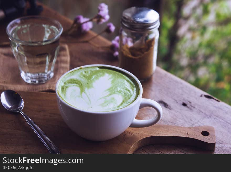 Green tea hot drink latte white cup on wood table aroma relax ti