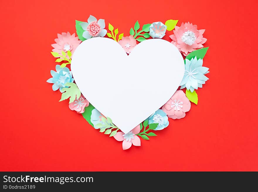 Heart frame with paper flowers with green leaves on red background. Cut from paper. Valentines day concept. Heart frame with paper flowers with green leaves on red background. Cut from paper. Valentines day concept