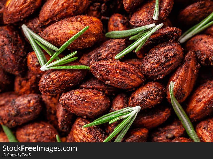 Concept of Spanish cuisine. Snack to wine or beer. Spicy almonds with pecias, rosemary, smoked paprkika, chili pepper, olive oil