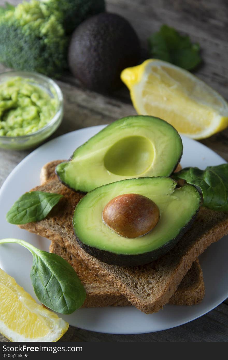 Delicious wholewheat toast with guacamole, avocado slices. Mexican cuisine. Healthy food, snack. Breakfast. Wooden rustic table