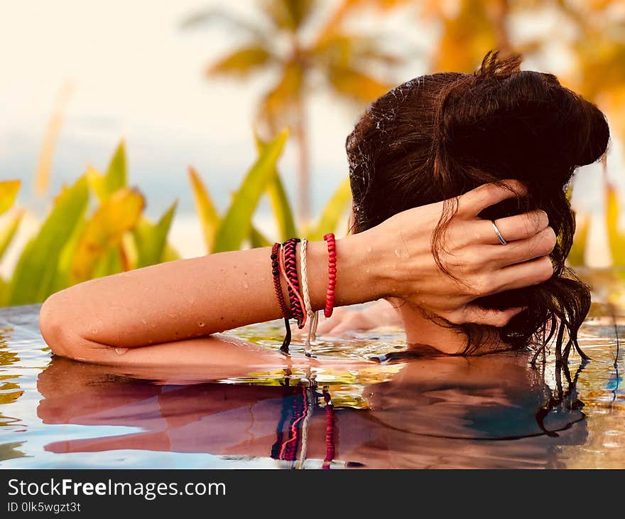 Young woman relax in the pool at Bali