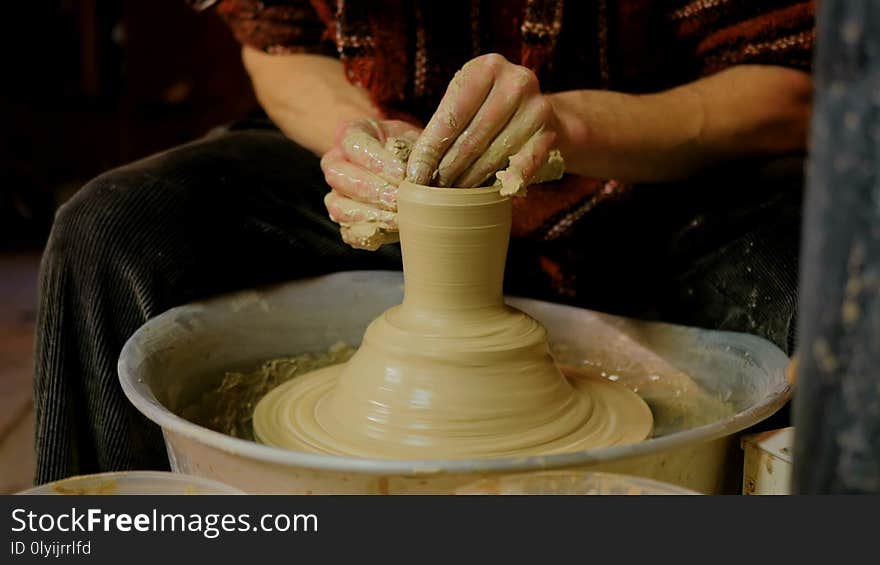 Professional male potter making mug in pottery workshop, studio. Handmade, art and handicraft concept