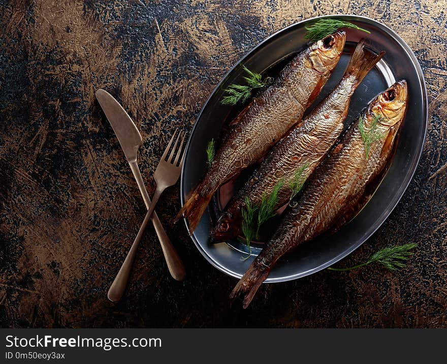 Smoked herring with dill on a metal dish. Copy space for your text. Smoked herring with dill on a metal dish. Copy space for your text.