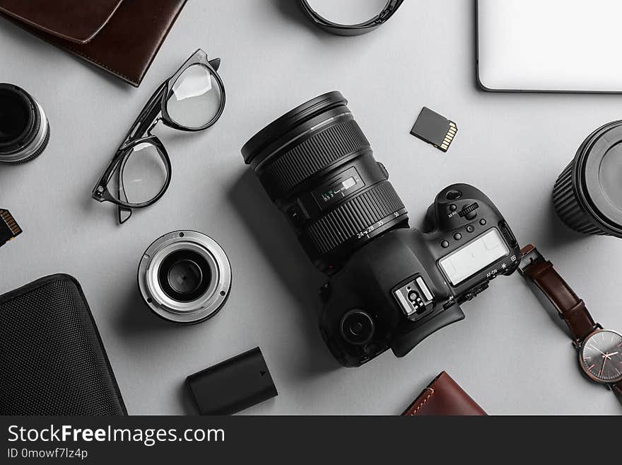 Flat lay composition with professional photographer equipment on light background