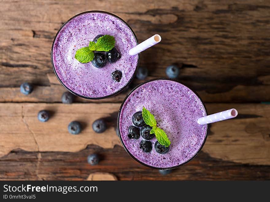 Blueberry smoothies juice,beverage healthy the taste yummy In glass,drink episode morning on white wood from the top view.