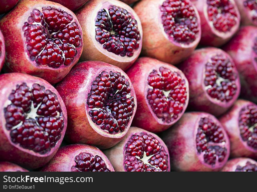 Many pomegranate cut in half, pomegranate background. Selective focus.