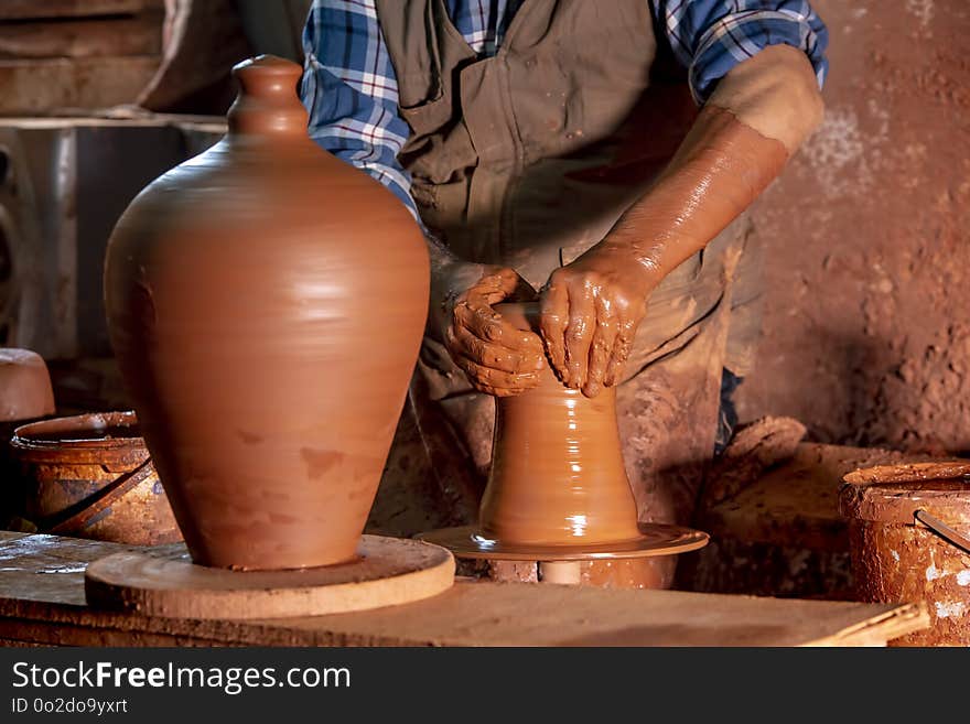 Professional potter making bowl in pottery workshop, studio