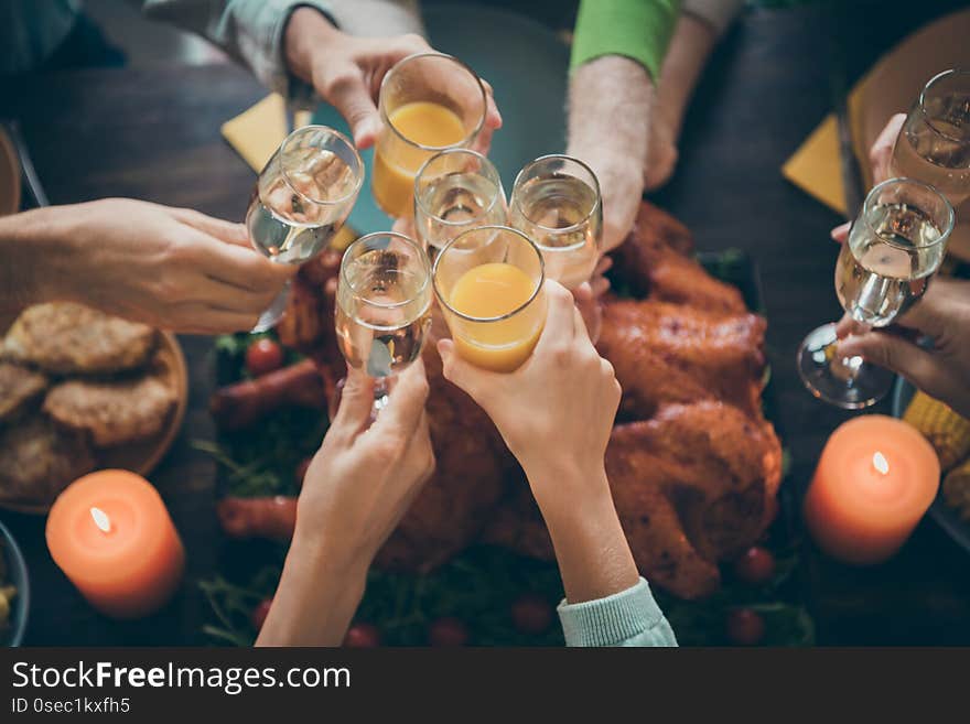 Cropped close-up view of nice big full family brother sister couples clinking glass orange juice beverage gratefulness