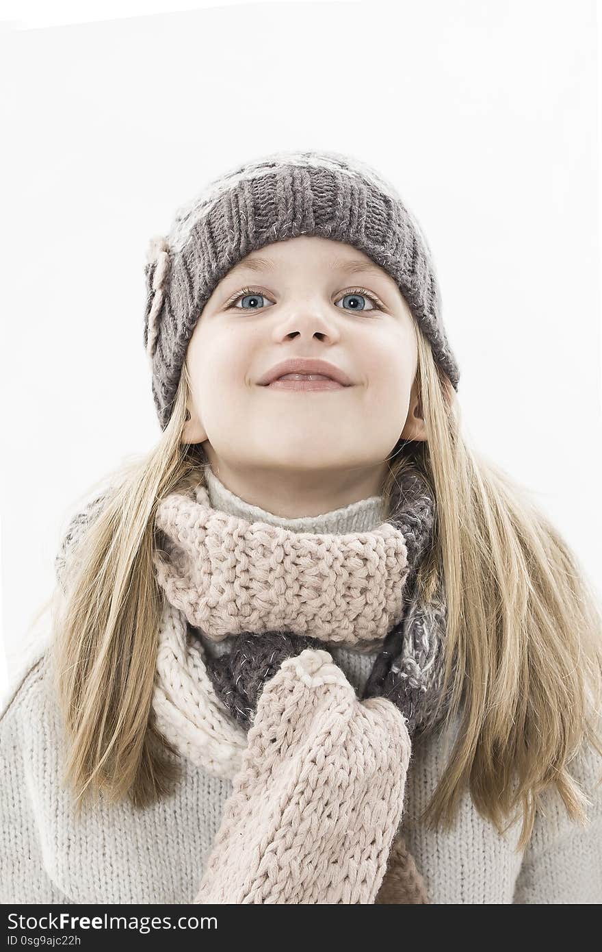 Adorable little girl in cap and scarf imagination. Winter style. Isolated on white background