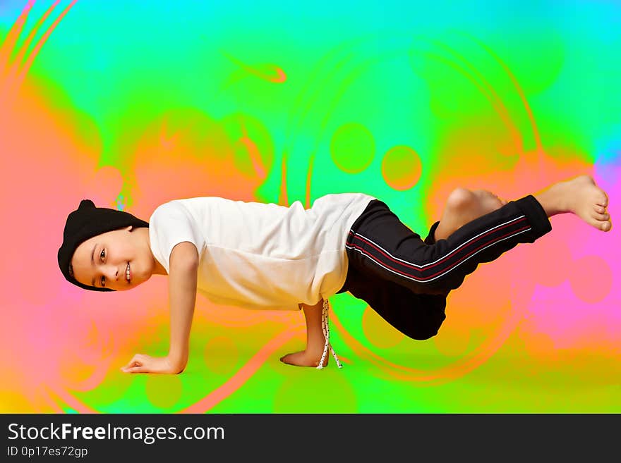 Break dance kids. little break dancer showing his skills in a dance studio. Hip-hop dancer boy performs on a bright background. Break dance kids. little break dancer showing his skills in a dance studio. Hip-hop dancer boy performs on a bright background