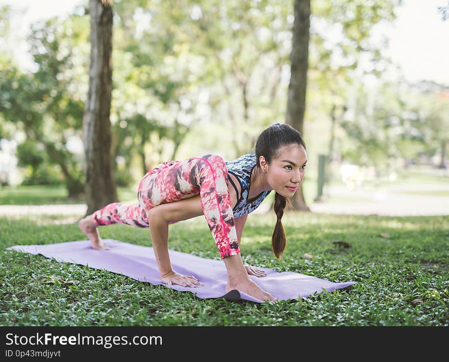 Yoga in the park healthy exercise. woman do lotus yoga pose.