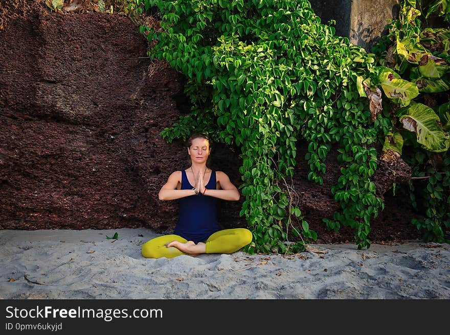 Portrait of happiness young woman practicing yoga on outdoors.Yoga and relax concept. Beautiful girl practice asana. Holiday in tropical country