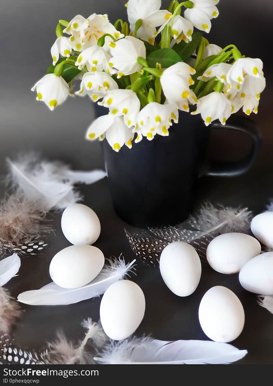 Eggs With Willow tree and  White Spring flower bouquet  still life green yellow red feathers down decoration easter yellow cu